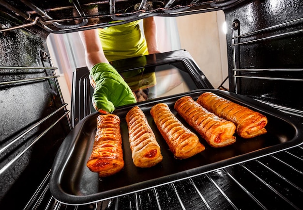 Housewife preparing cakes in the oven at home, view from the inside of the oven. Cooking in the oven.