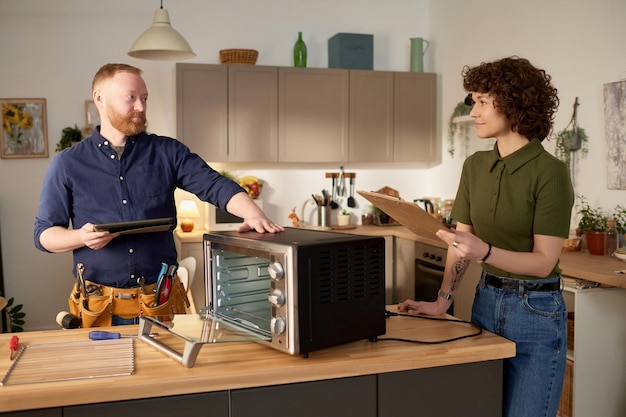 Housewife signing contract with repairman