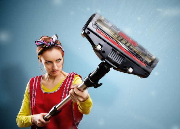 Housewife with vacuum cleaner