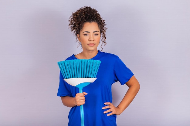 Housewife woman. Cleaner. Young man holding broom on white background with free space for text.