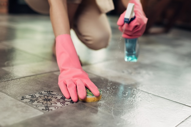 Housework and housekeeping concept. Woman cleaning floor with mop indoors