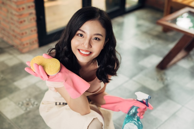 Housework and housekeeping concept. Woman cleaning floor with mop indoors