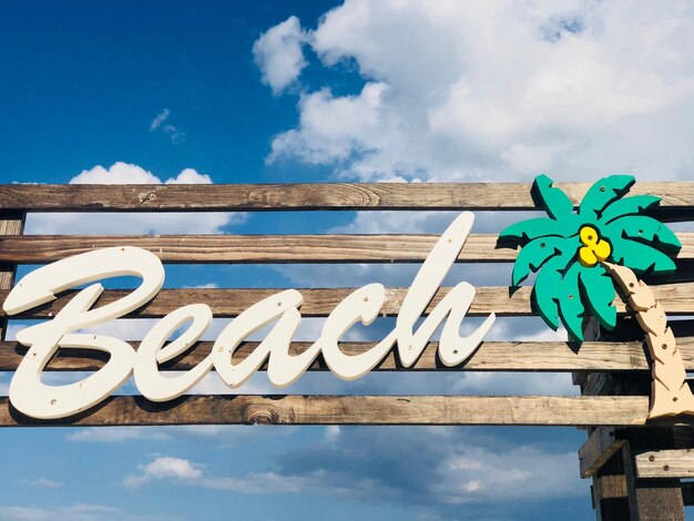 Foto houten bord met het woord strand met blauwe hemel op de achtergrond