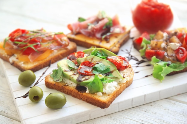 Houten bord met lekkere broodjes op tafel