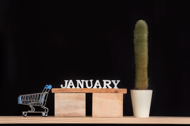 Houten kalender van januari cactus en miniatuur trolley kaart