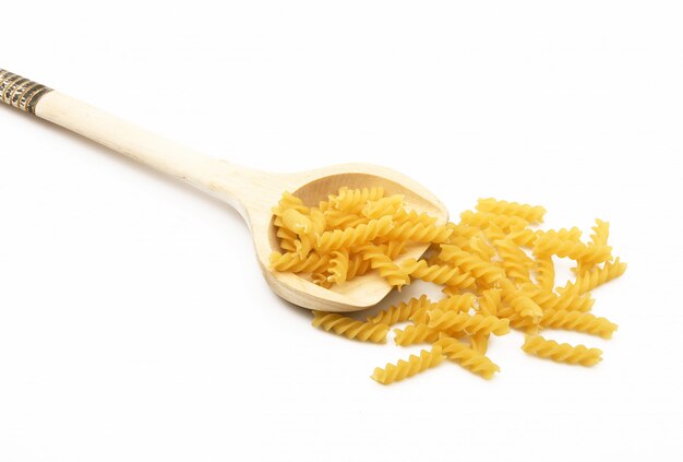 Houten lepel met italiaanse pasta op witte achtergrond