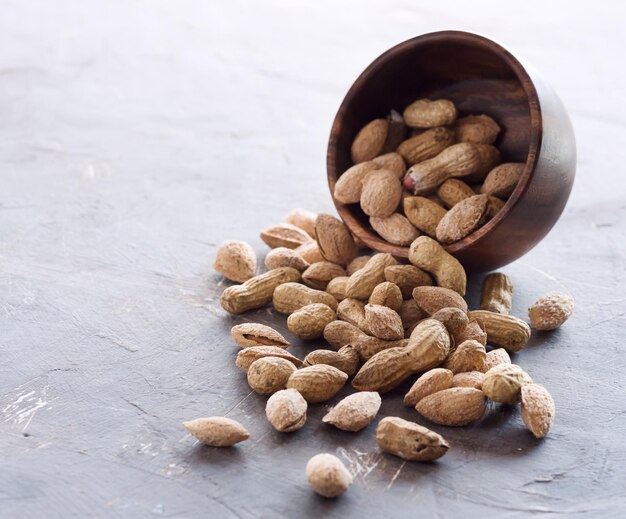 Houten schaal met ongepelde noten Noten Amandelpinda's Gezonde snack Vierkante foto