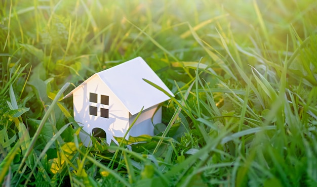 Houten speelgoed huis op een achtergrond van groen gras