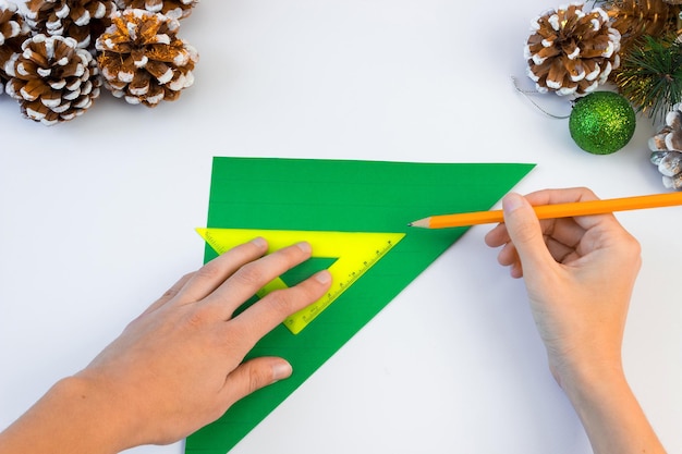 How to make a creative Christmas tree from colored paper and glue with your own hands. DIY concept. Step-by-step instruction.