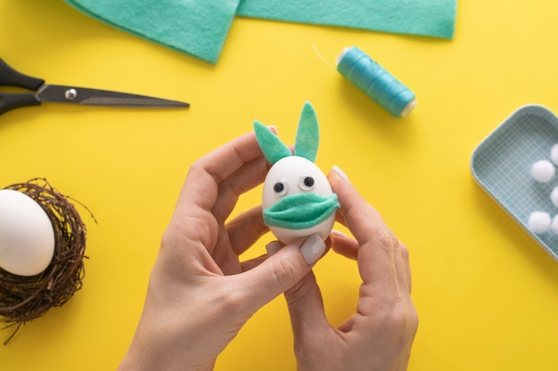 How to make felt bunny for Easter decor and fun.  DIY concept. Step by step  instruction. Step 13. We glue the ears to the bunny.