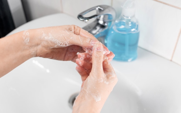 How to wash your hands to prevent the epidemic of coronavirus, Covid-19, flu. Young woman washes hands with soap