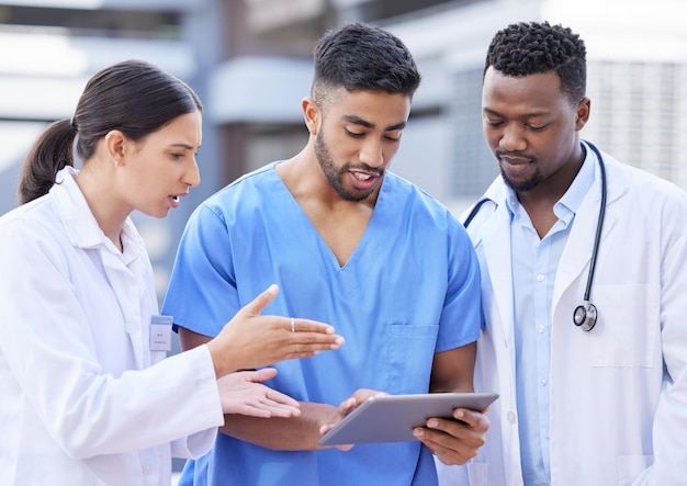 How do we fix this Shot of a group of doctors using a digital tablet against a city background