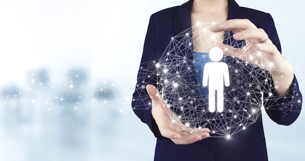 HR Human Resources Recruitment Employment. Two hand holding virtual holographic Human, Leader icon with light blurred background. Social media concept. Communication network.