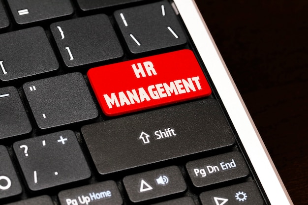 HR Management on Red Enter Button on black keyboard.