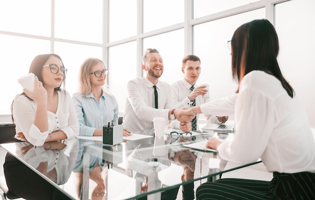 HR Manager greets the candidate with a handshake.