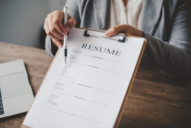 HR managers offer job applications to job applicants to fill out a resume on the job application form to apply for work in the company.