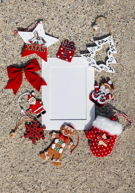 Photo hristmas composition with mock up on sand background flat lay top view christmas card