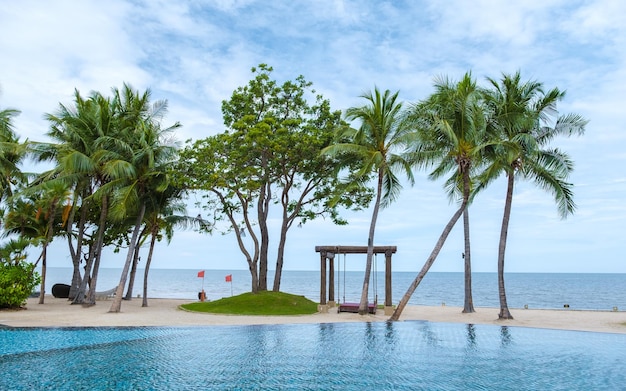 Hua hin thailand tropical pool with palm trees at a luxury resort of movenpick in huahin