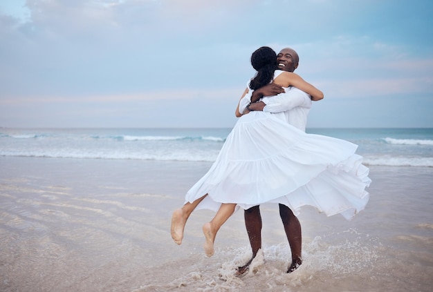 hug honeymoon and black couple playing at beach for love trust or travel together on date smile sea or happy people romantic anniversary for holiday loyalty or marriage commitment in mauritius