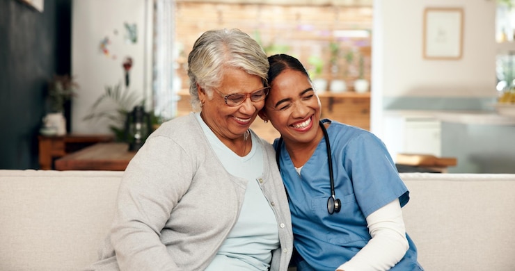 Photo hug senior woman and nurse with stethoscope in nursing home for retirement wellness and elderly care female people medic and embrace as caregiver staff and support for appointment or check up