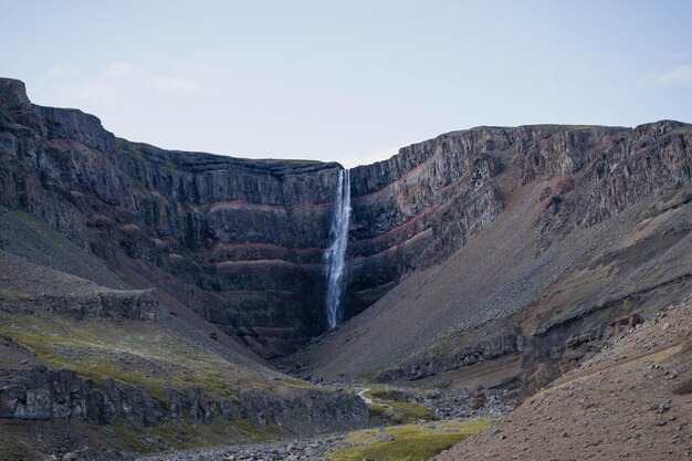 Huge blue waterfall flowing down the mountain