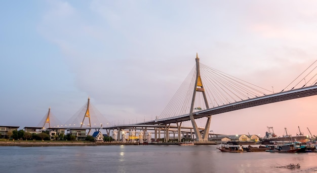 Huge bridge Thai letter mean name 'Bhumiphol' cross Chaophraya river in Bangkok evening twilight sky