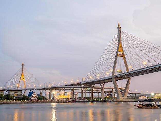 Huge bridge Thai letter mean name 'Bhumiphol' cross Chaophraya river in Bangkok evening twilight sky