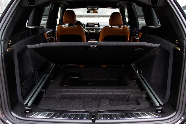 Huge clean and empty car trunk in interior of compact suv Rear view of a SUV car with open trunk