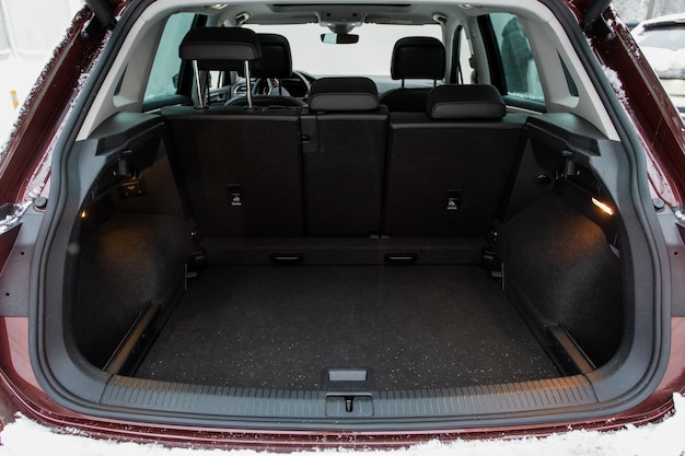 Huge clean and empty car trunk in interior of compact suv Rear view of a SUV car with open trunk