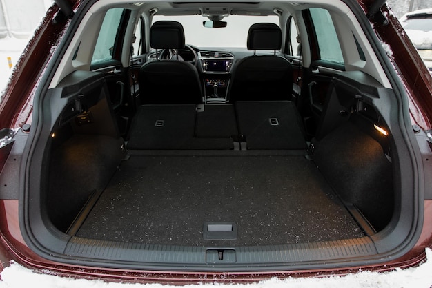 Huge clean and empty car trunk in interior of compact suv Rear view of a SUV car with open trunk
