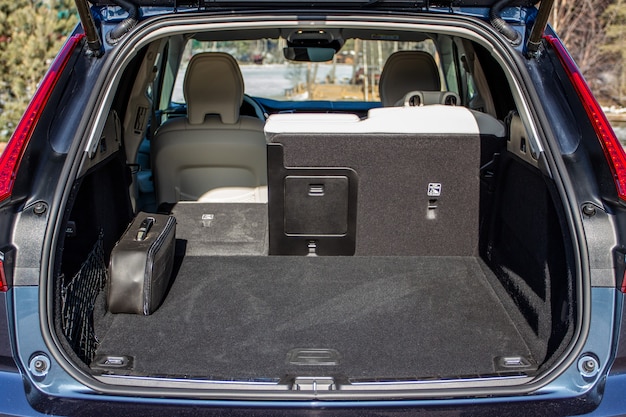 Huge, clean and empty car trunk in interior of a modern compact suv. Rear view of a SUV car with open trunk. Car trunk interior.