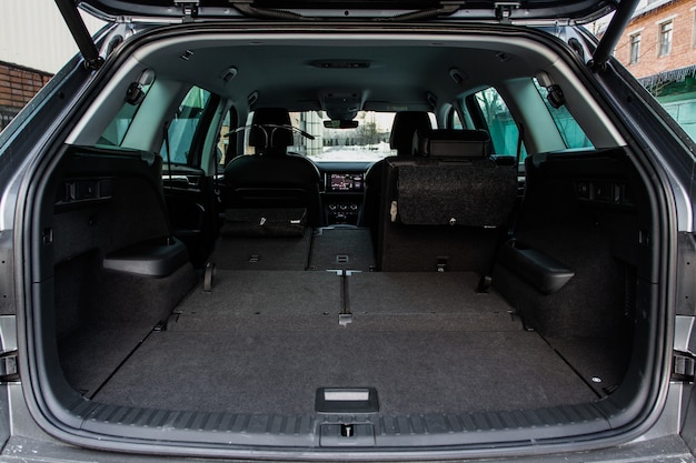 Huge, clean and empty car trunk in interior of a modern compact suv. Rear view of a SUV car with open trunk. Car trunk interior.