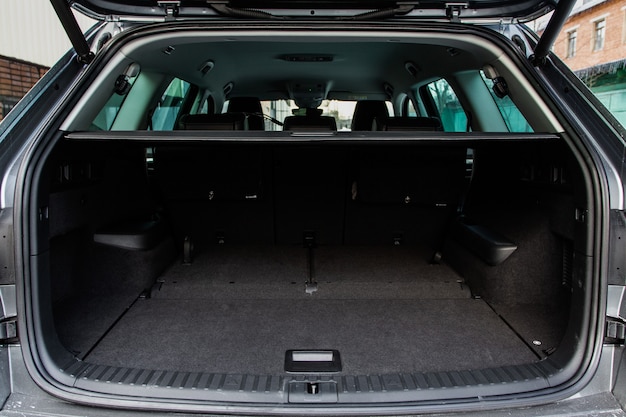 Huge, clean and empty car trunk in interior of a modern compact suv. Rear view of a SUV car with open trunk. Car trunk interior.