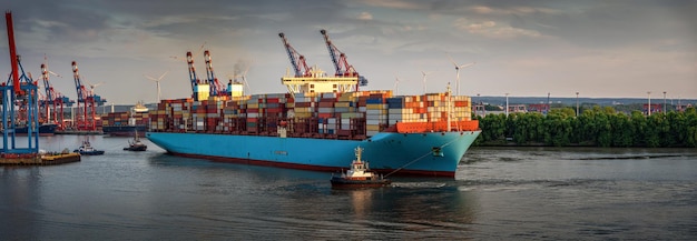 huge container ship at sunset in the port of Hamburg