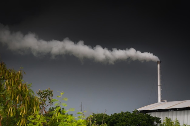 Photo huge factory chimney polluting the air,tall chimney emitting  water vapor and smoke pollution,industry causing pollution
