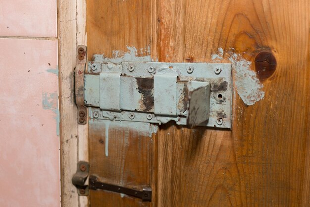 A huge homemade deadbolt lock on the door of the production room