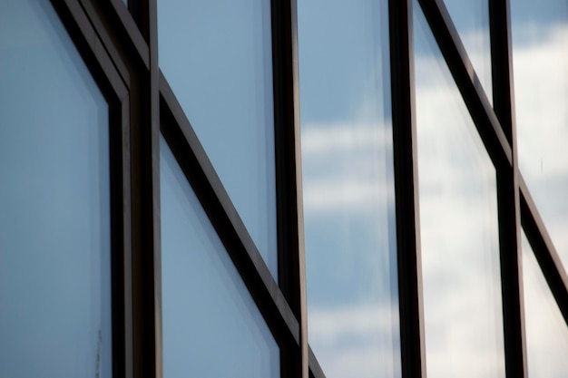 Huge modern windows with blue sky and clouds reflection horizontal photo