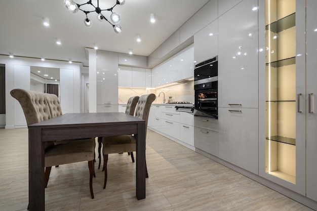 Huge white luxury kitchen in a studio apartment interior