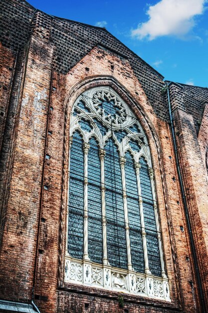 Huge window in San Petronio cathedral side wall in Bologna Italy