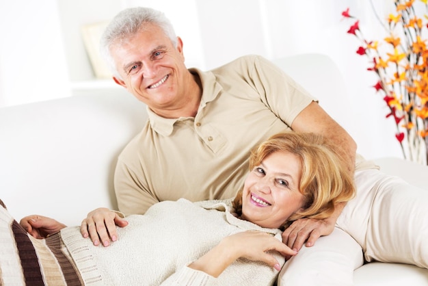 Hugging Senior couple in living room.