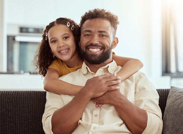 Hugging sofa and portrait of child with father for love care and bonding together in home Smile connection and girl kid embracing dad for relax in living room on weekend at house in Colombia