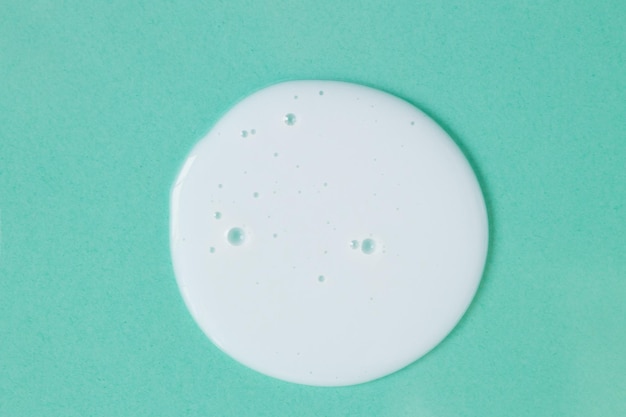 Huidverzorging cosmetische crème lotion staal uitstrijkje vlek op mint kleur achtergrond Witte romige hygiëne be