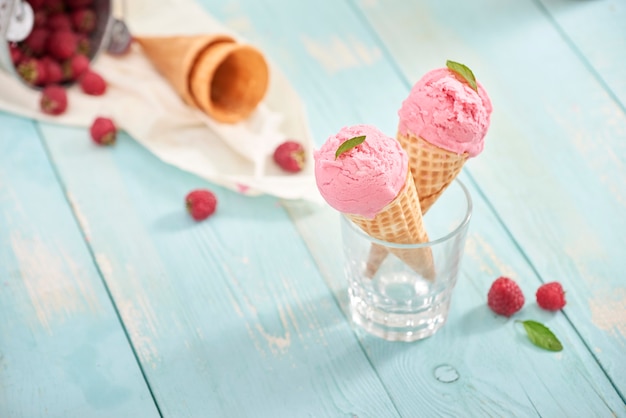 Huisgemaakt frambozenroomijs in wafelkegels. Zomertijd