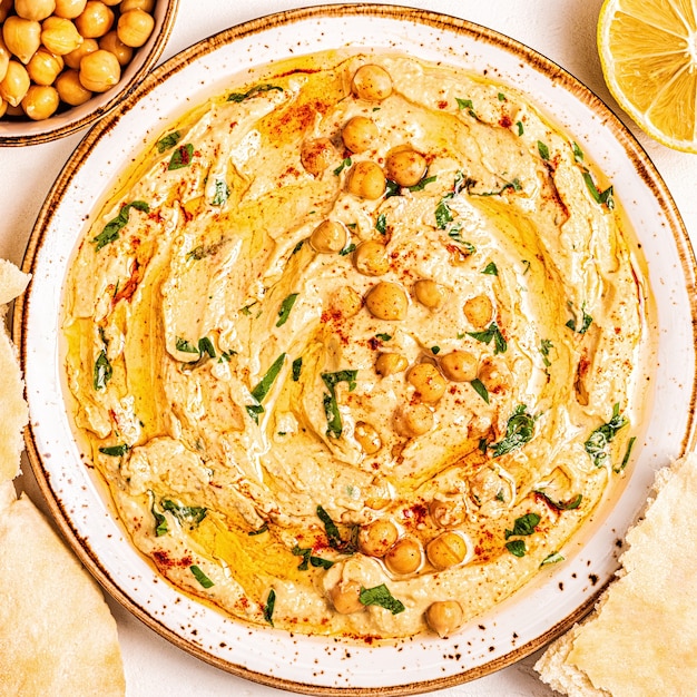 Huisgemaakte hummus, kikkererwtendip, met kruiden. Bovenaanzicht.