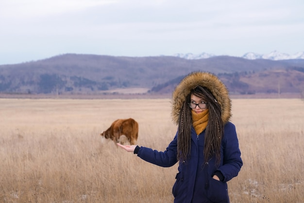 Human and animal girl holds cow on her palm hand