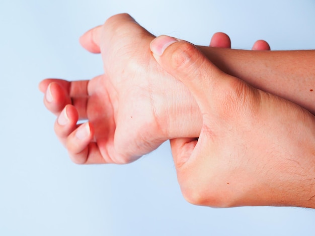 Human body suffer with wrist pain isolated on blue background