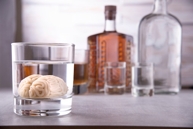 Human brain in a glass with an alcoholic drink