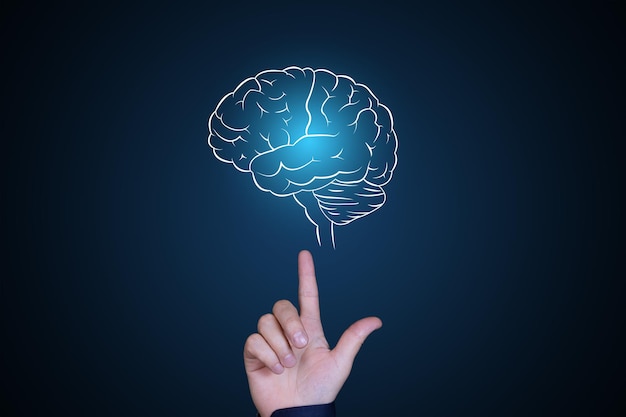 Human brain in neon glow. The hand points to the brain. Human psychology, artificial intelligence, brainstorming, thinking concept. Copy space. High quality photo