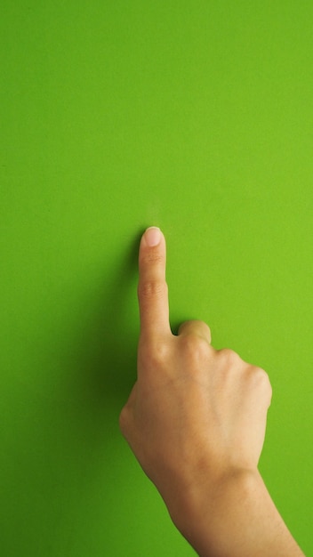 Human finger touching or pointing on green screen