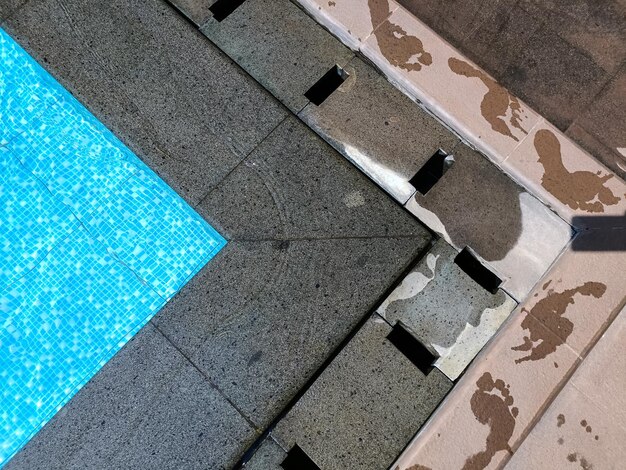 Human foot prints at the edge of a swimming pool